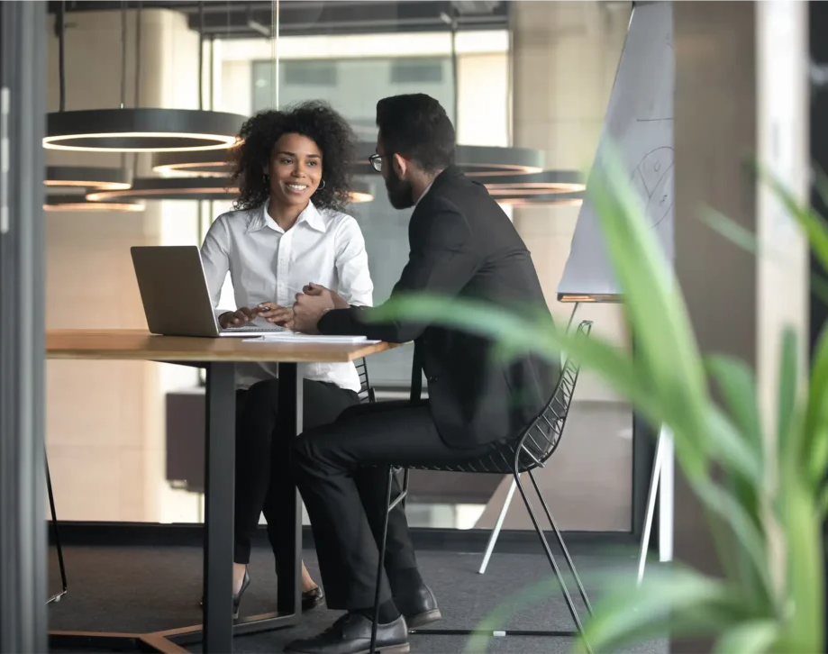 A man and woman are sitting at a table.